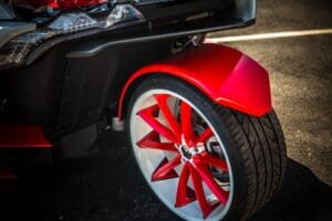 A red and black car with white rims