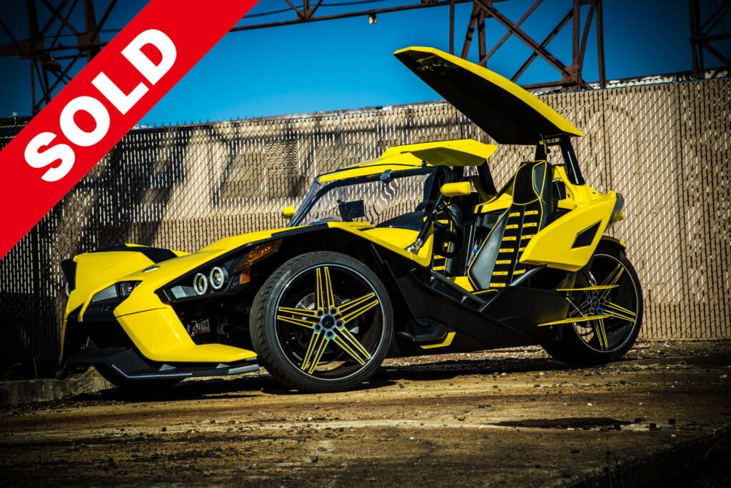 A yellow and black car with the hood open