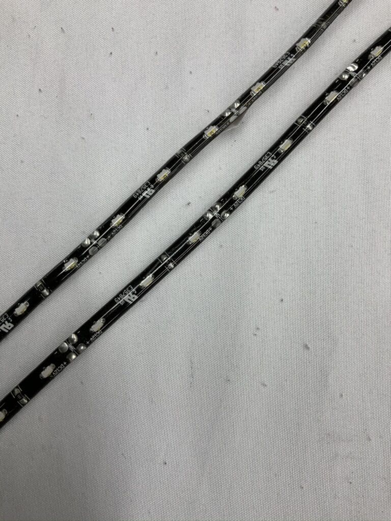 A pair of black and white striped chain link necklaces.