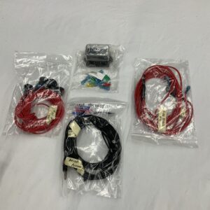 Wires in Red and Black in Plastic Covers on a Surface