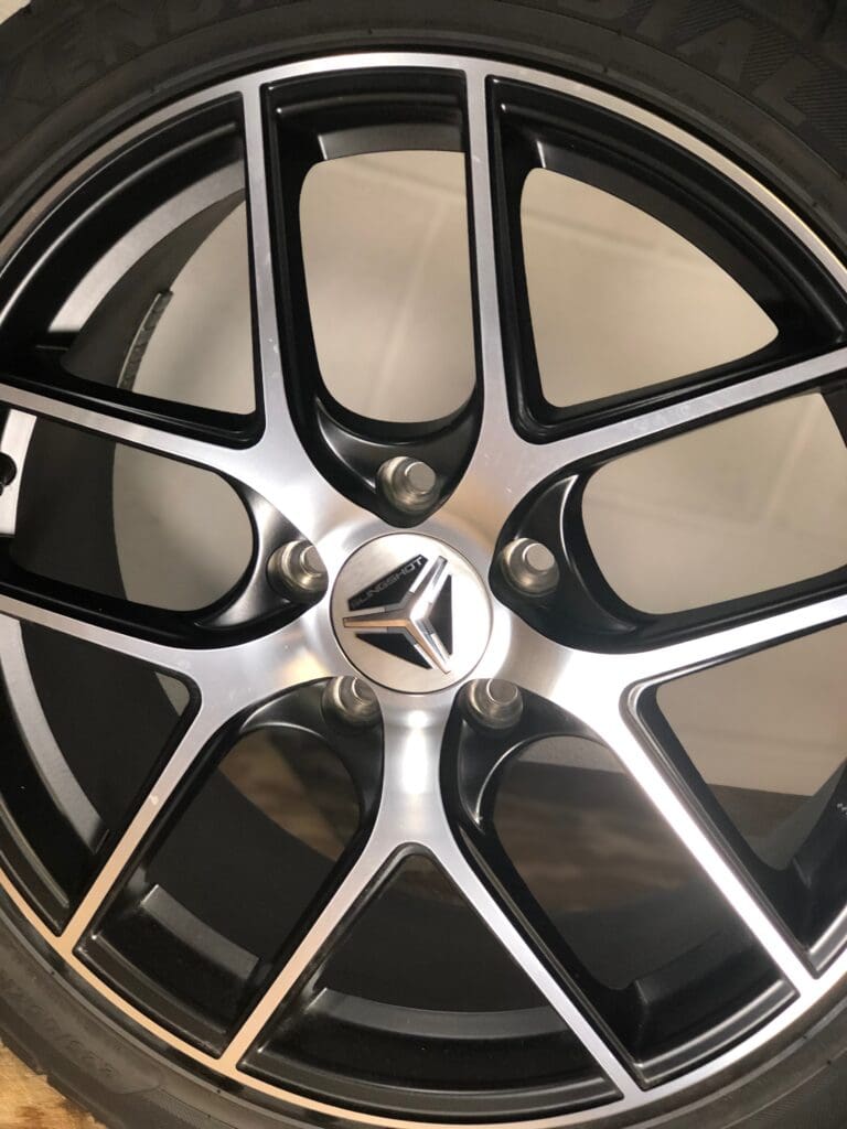 A close up of the rim and tire on a car