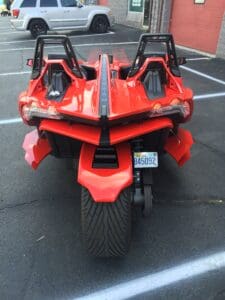 A red motorcycle parked in the parking lot.
