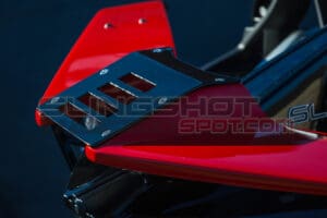 A red and black motorcycle seat on top of a table.