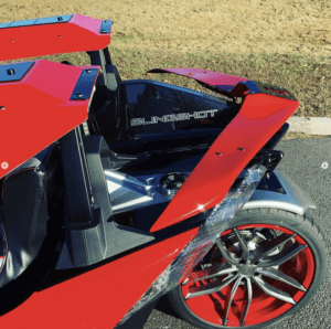 A red motorcycle parked on the side of a road.