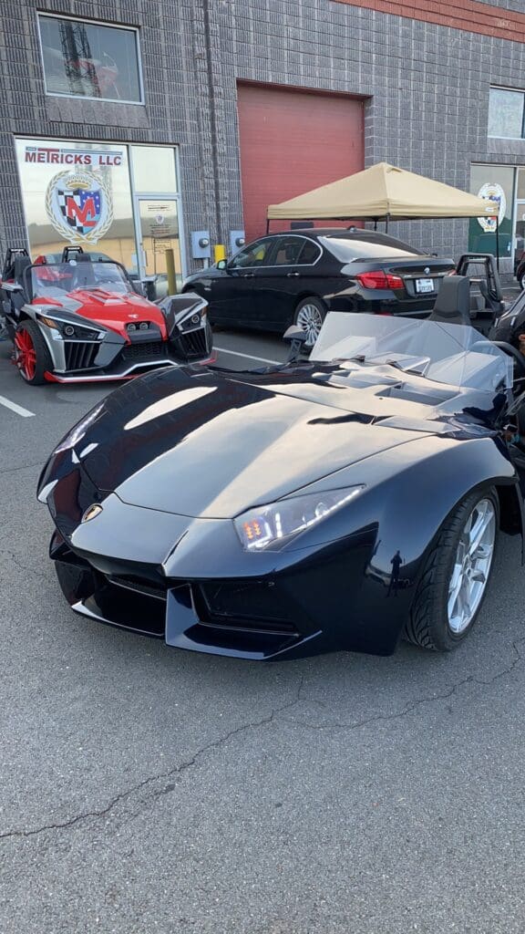 A black and silver car parked in the street