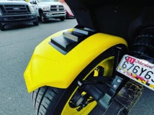 A close up of the rear wheel on a motorcycle.