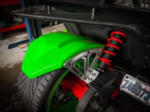 A green motorcycle with red and black tires.