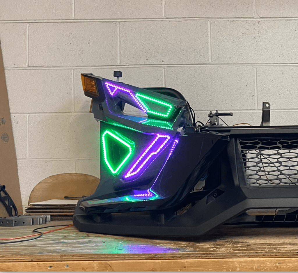 A neon sign sitting on top of a desk.