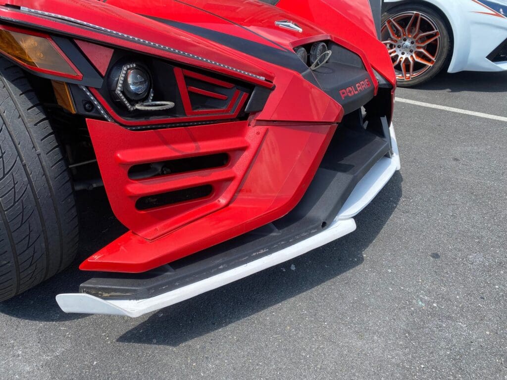 Red Polaris Slingshot front bumper close-up.