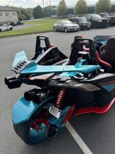 Two parked blue three-wheeled vehicles.